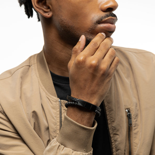 Man wearing the trio stack bracelet on his wrist, styled with a tan jacket.