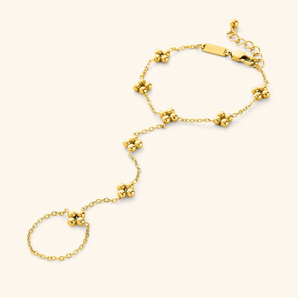 Close-up of the Henna Hand Chain in 18K gold plating, featuring intricate henna-inspired floral and paisley patterns forming an elegant hand bracelet connected to a ring.
