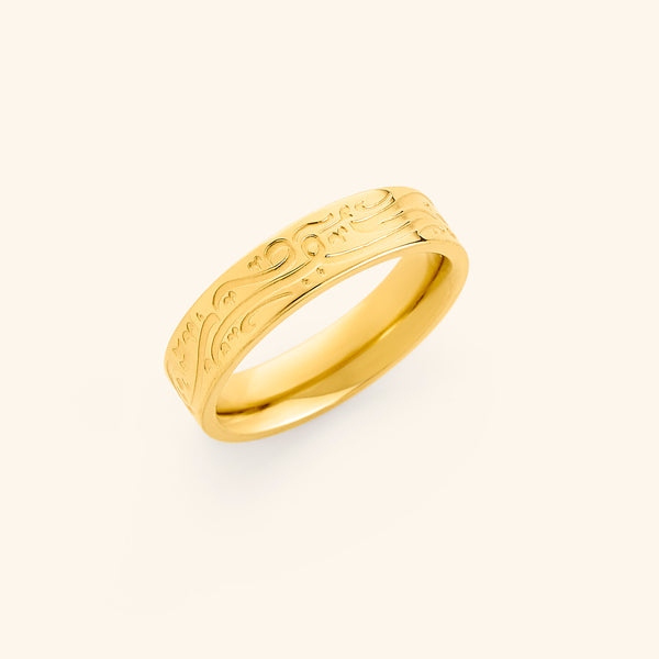 Gold ring with engraved Arabic calligraphy meaning “Be, and it is,”.