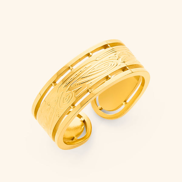 The image shows a gold wrap ring with intricate designs. The ring appears to be made of gold and features detailed patterns. The text "Aadhil x Nominal Wrap Ring" suggests this is a product shot for a ring, likely a collaboration between Aadil and Nominal.